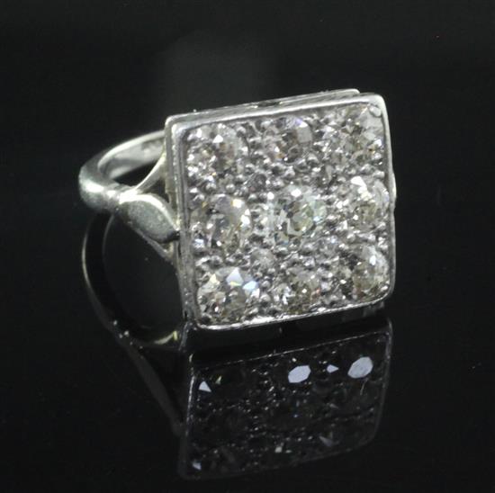 A 1940s/1950s platinum and nine stone diamond set tablet ring, size N.